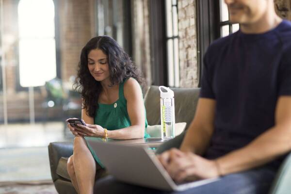 Woman sitting down looking at phone