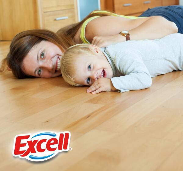 happy mom and child on wooden floor in home
